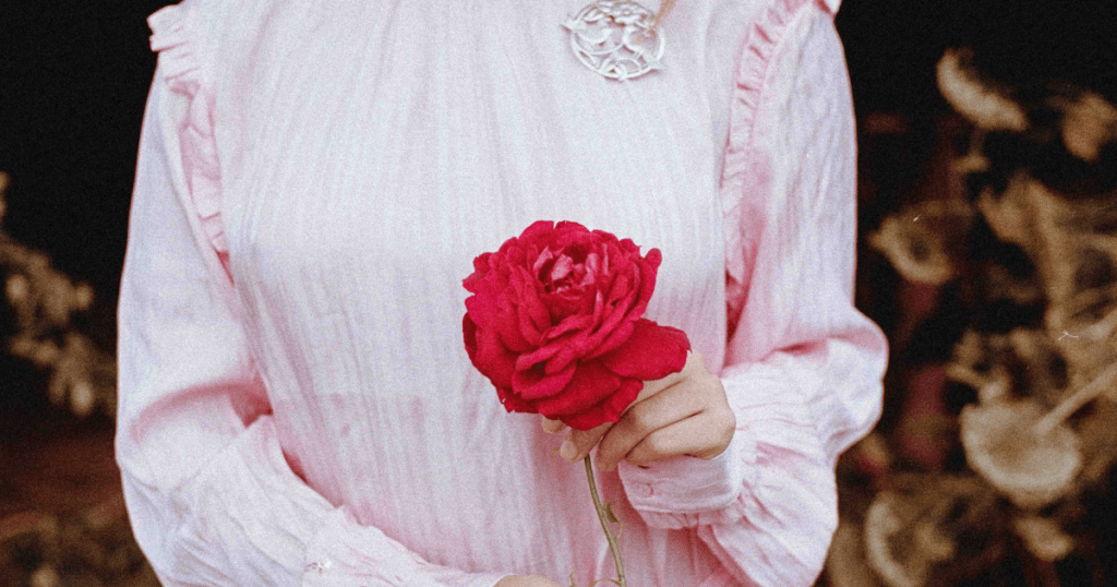 woman holding a rose flower